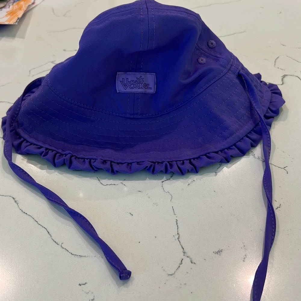 Purple UV Skins hats with chin tie strap, size 3-6 months